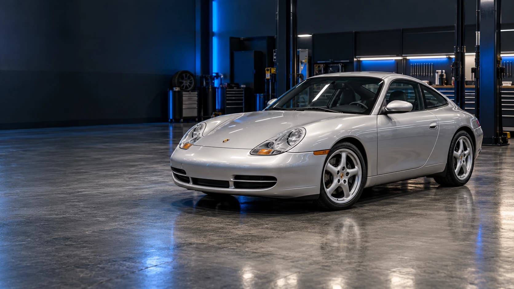 Silver 1999–2004 Porsche 911 Carrera 996 photographed in a specialist performance workshop