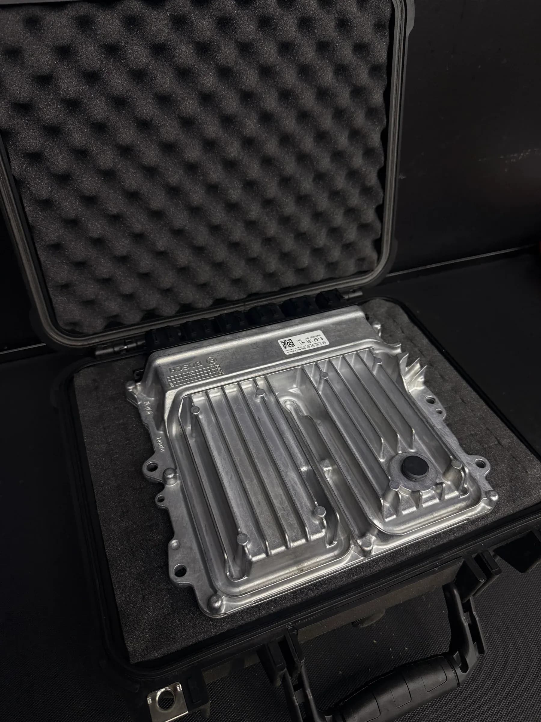 BMW Bosch engine control unit secured in a protective case for an in-house ECU unlock