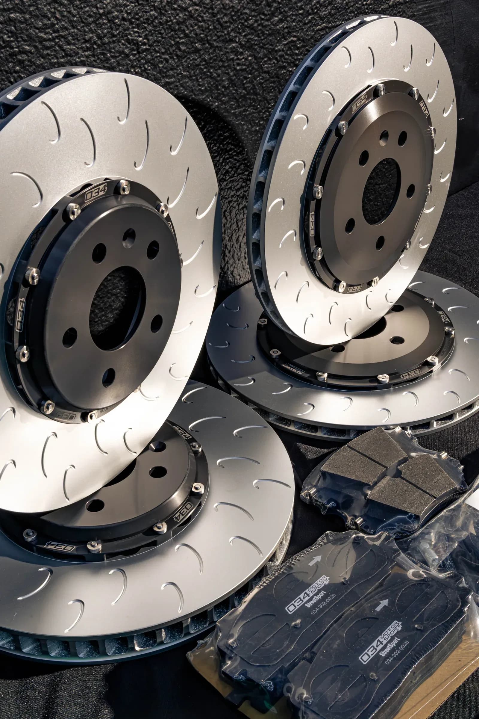 Performance brake rotors and pads prepared for installation at Speedhaus Automotive