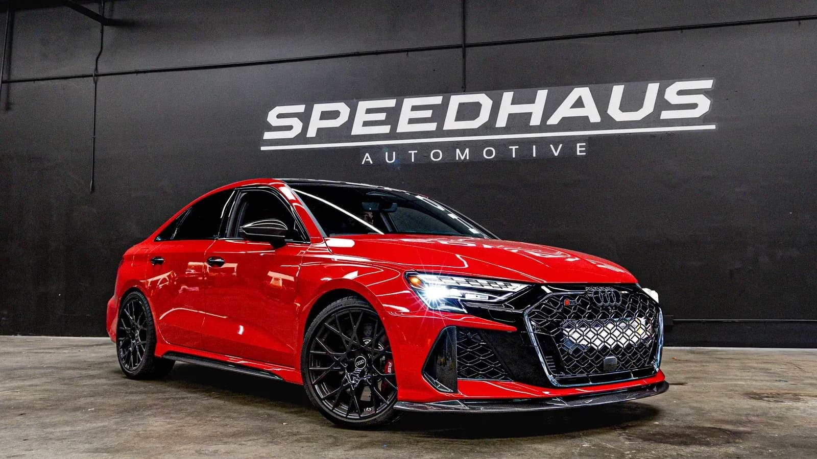 Red Audi RS performance sedan photographed inside the new Speedhaus Automotive workshop