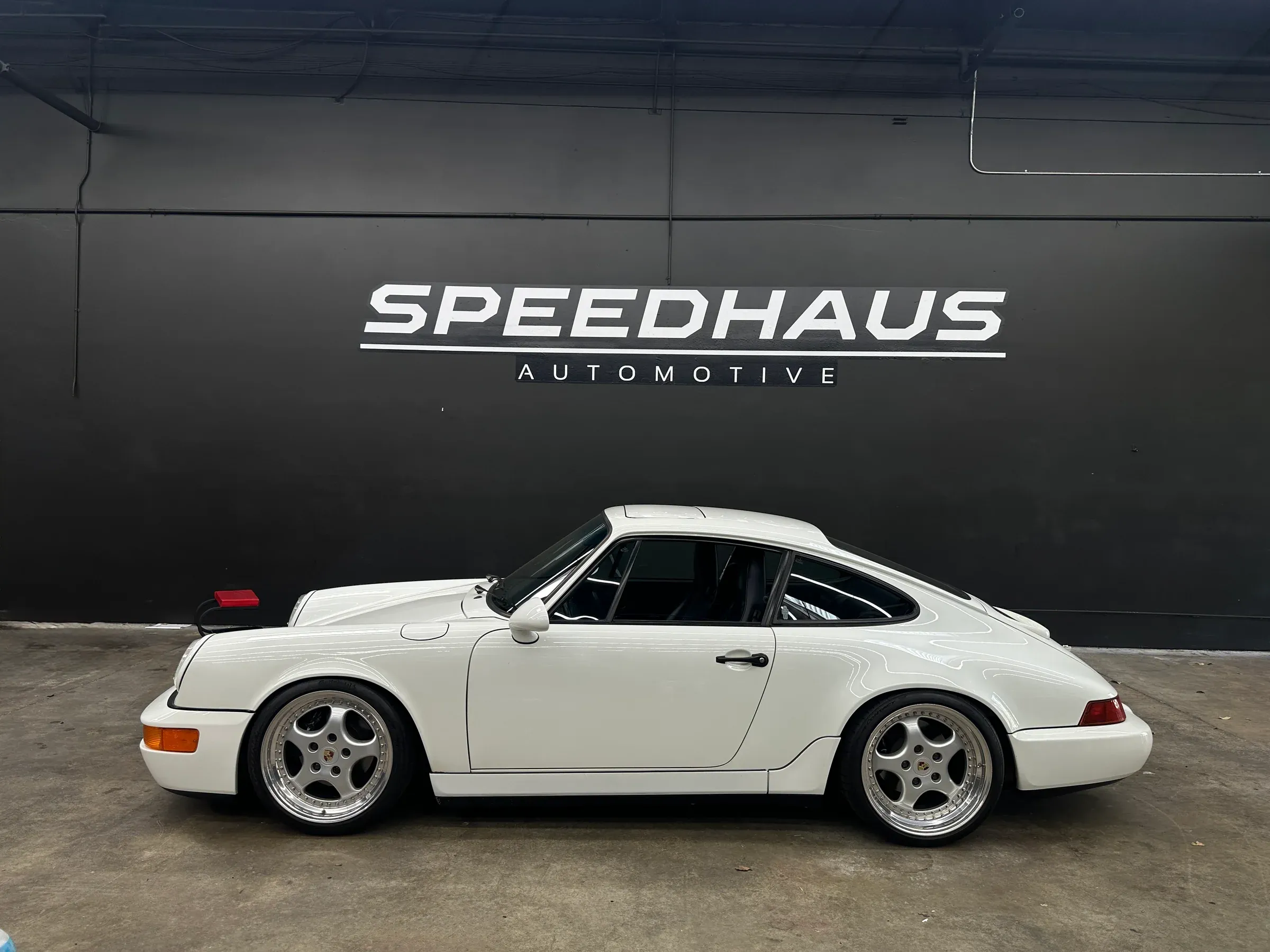 White classic Porsche 911 photographed in profile inside the new Speedhaus workshop